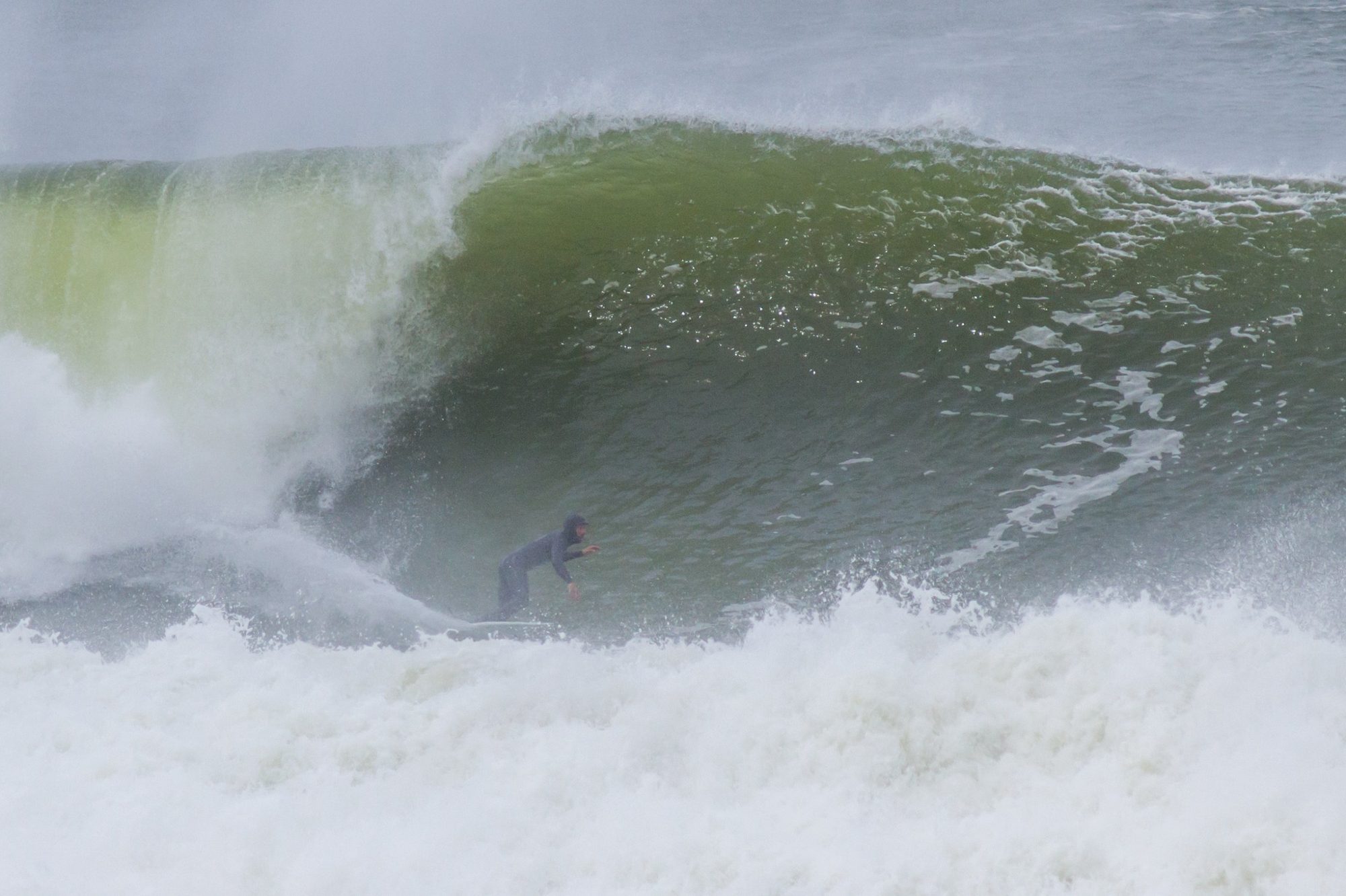A surfer inside a big green wave at La Paloma, with white water in front.