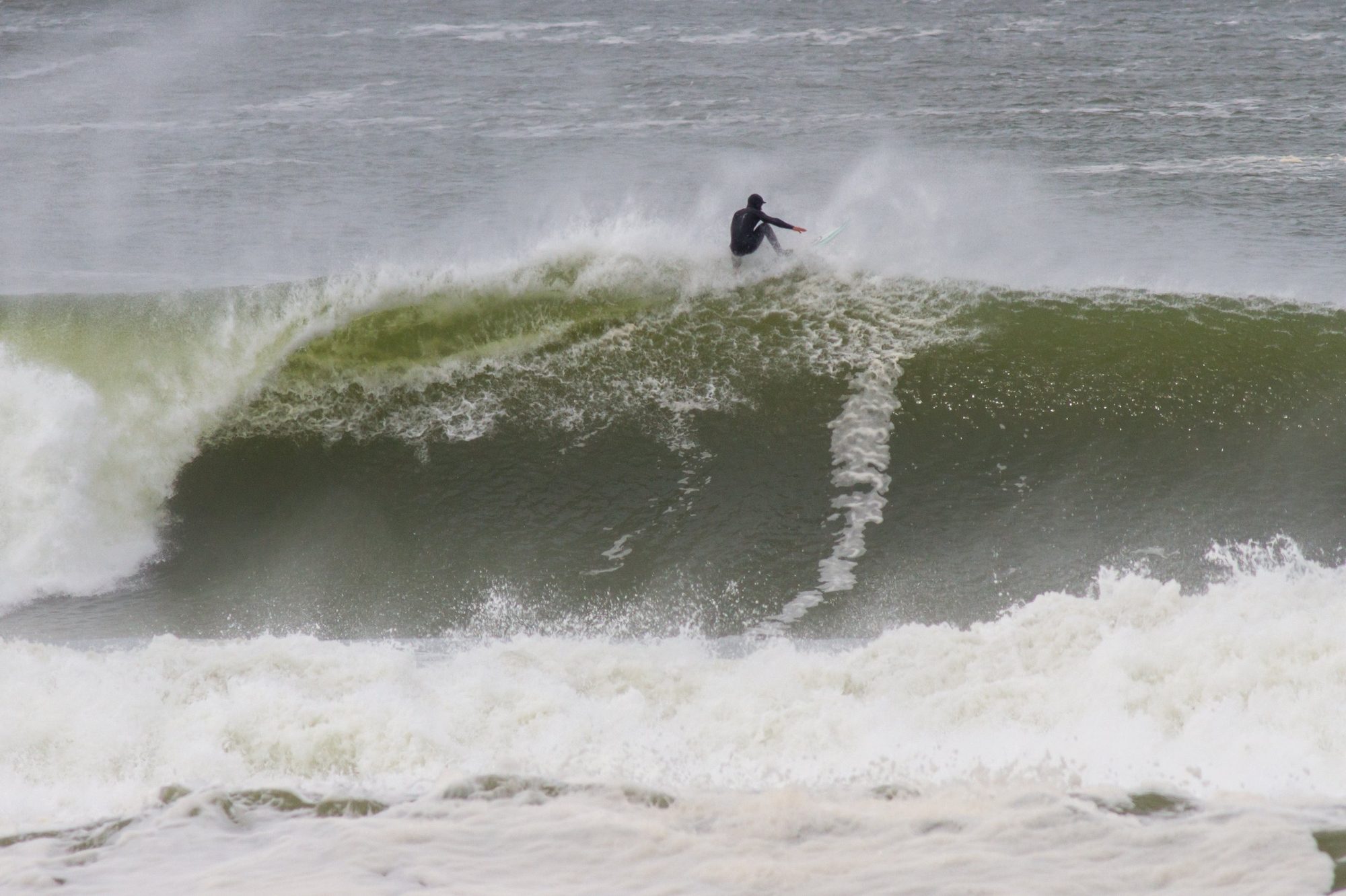 A surfer at the top of a wave at La Paloma, after the storm.